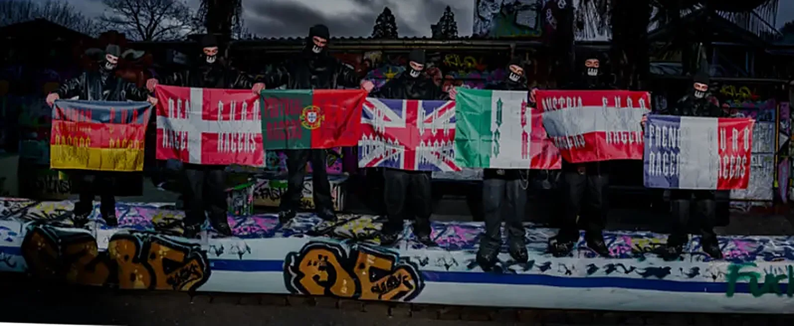 EURORAGERS crew in masks holding their country flags in front of a graffiti wall